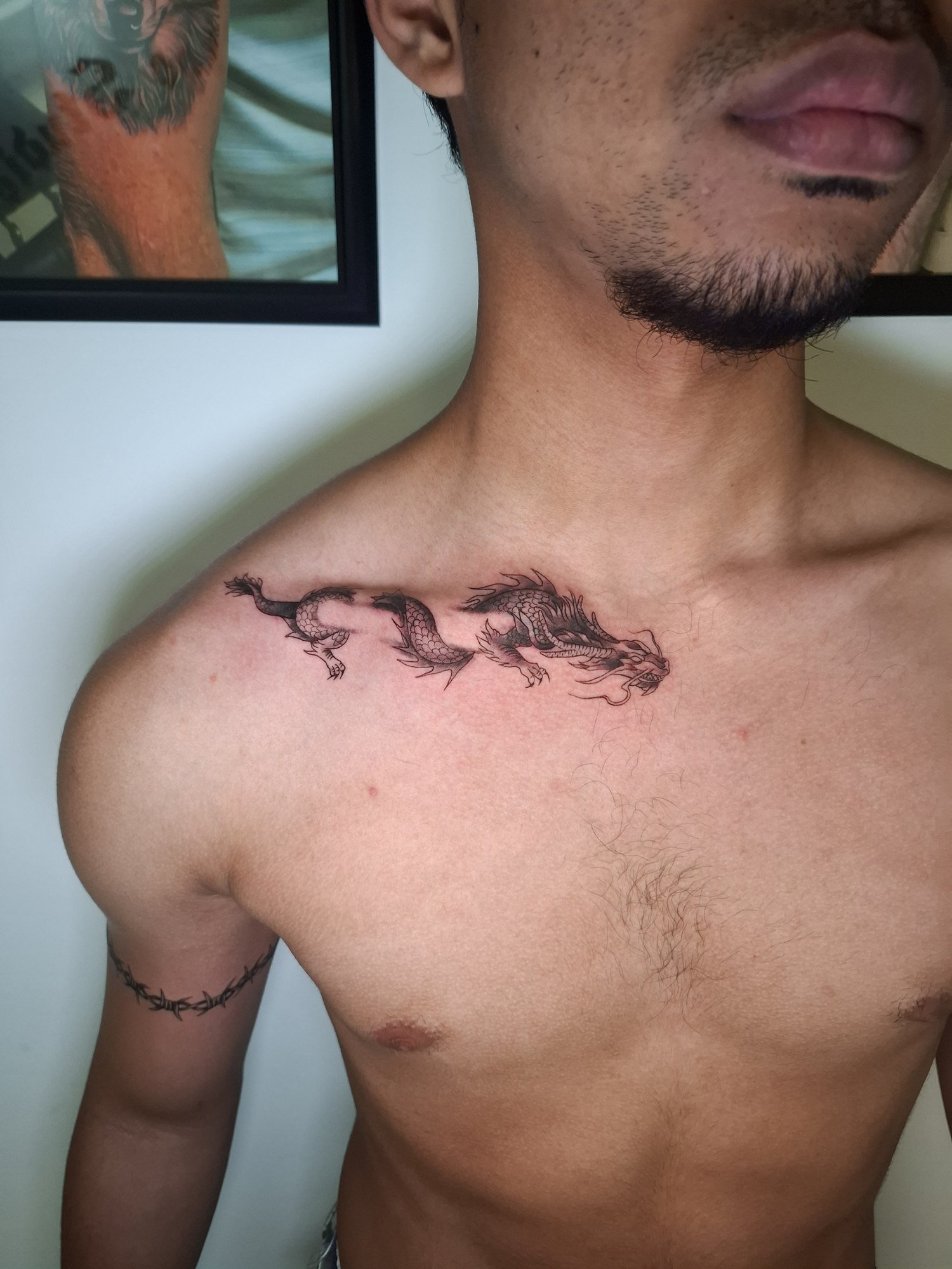 A winding dragon with fine scales and flowing whiskers along the collarbone. Tattoo by Edboi